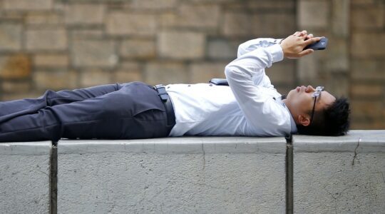 a students examines his cell phone