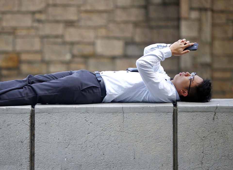 a students examines his cell phone