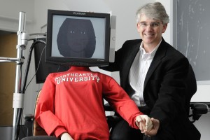 Timothy Bickmore next to a computer screen