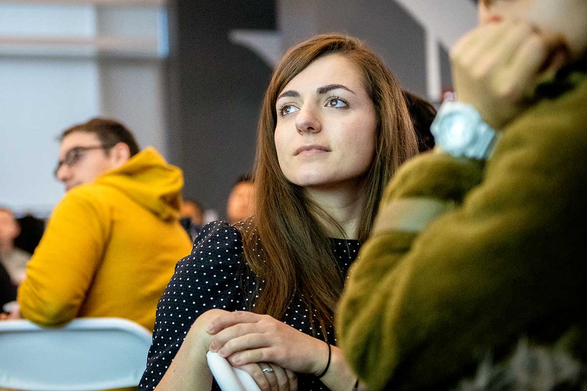 A student turned around in her chair views a presentation in a Khoury lab