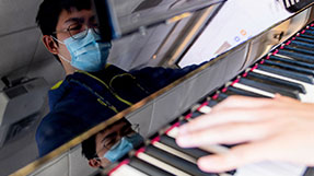 Yuehao Gao, who studies computer science combined with music, plays the piano in Ryder Hall on Jan. 25, 2021. Photo Matthew Modoono/Northeastern University