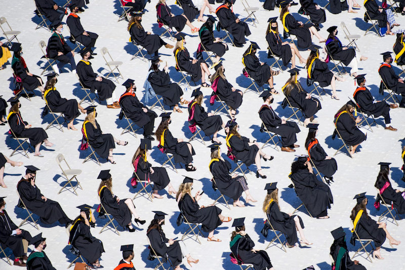 Graduates sitting in the field