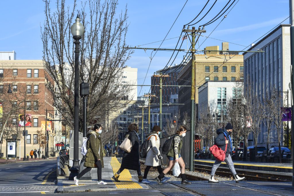 students walking across train tracks