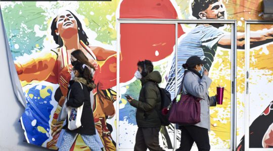 students walking in front of Northeastern University's mural
