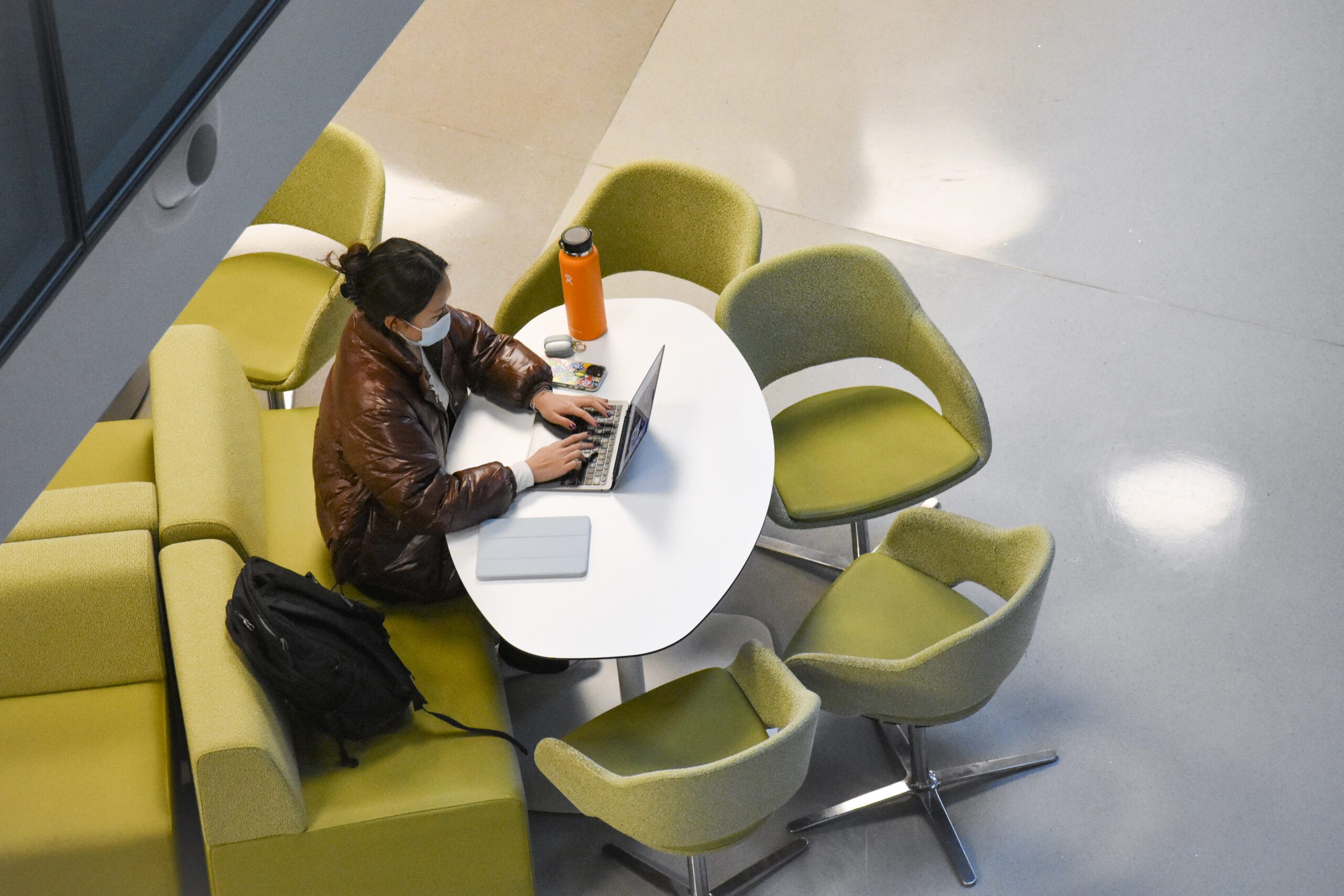 student sitting and doing work at a table