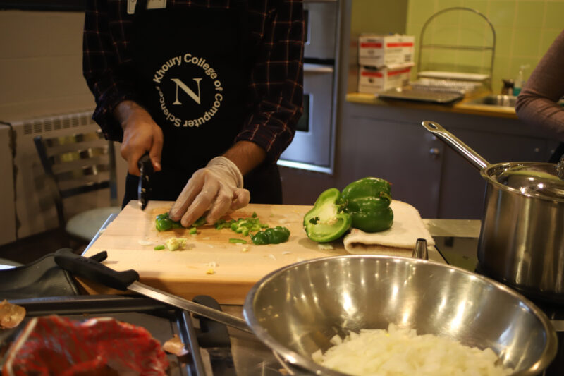 man slicing a pepper in the kitchen