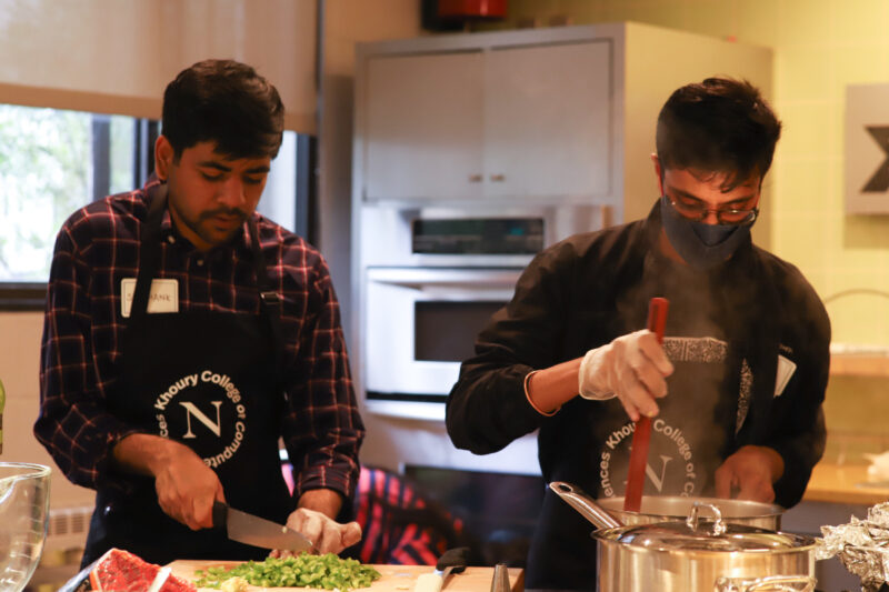 two men cooking in the kitchen