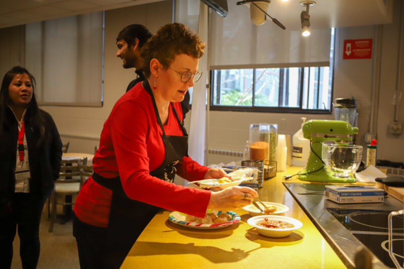 dean cooking with students in kitchen