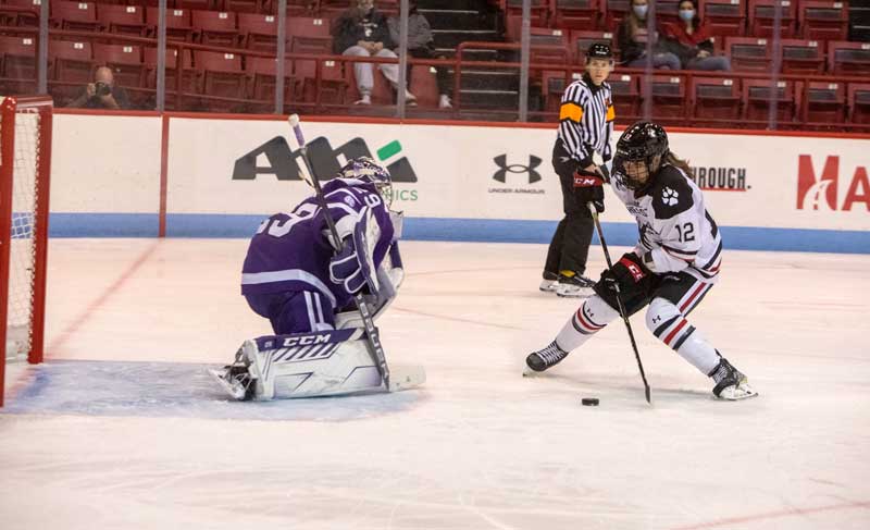 Chloé Aurard attacks the net against Holy Cross. Photo by Sarah Olender. 