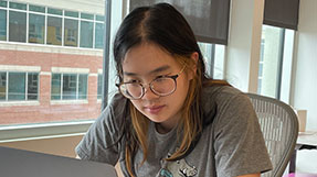 Millicent Li works at a desk