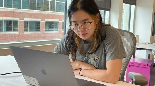 Millicent Li works at a desk