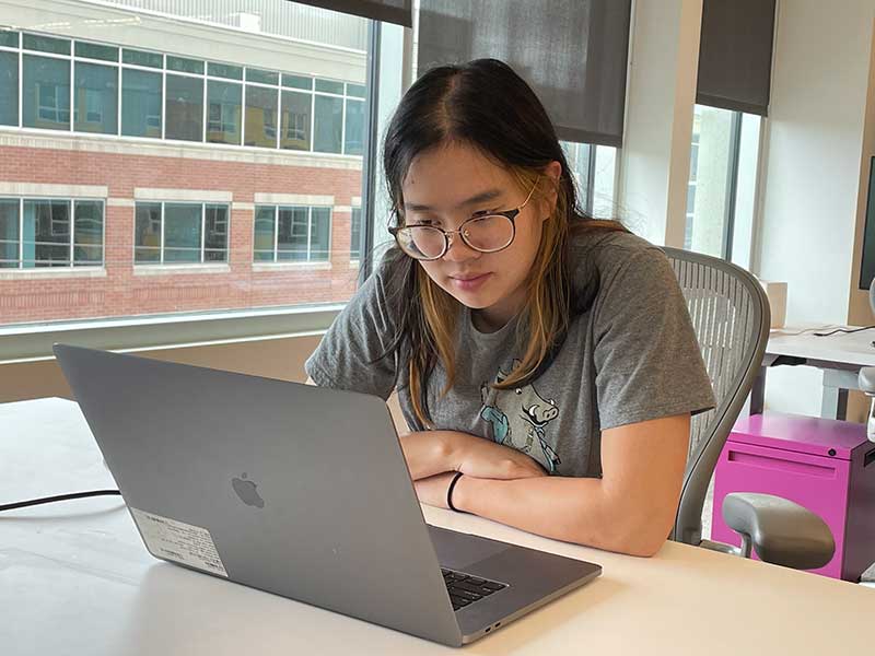 Millicent Li works at a desk