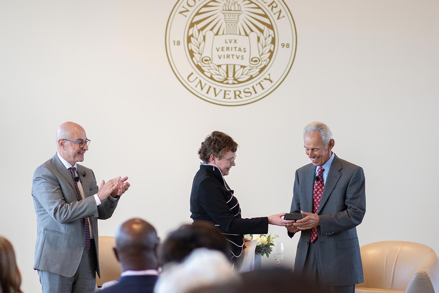 Mynatt presents Khoury with the first of the college’s 40 for 40 Awards as Aoun looks on.