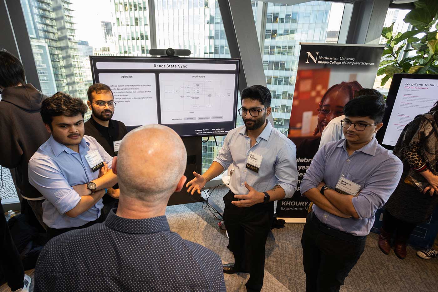 A team of four students explains its research project, 'React State Sync.' Photo by Jesse Winter.