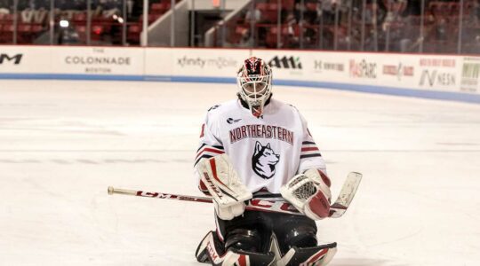 Devon Levi kneels on the ice