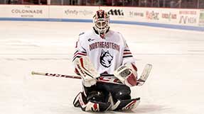 Devon Levi kneels on the ice