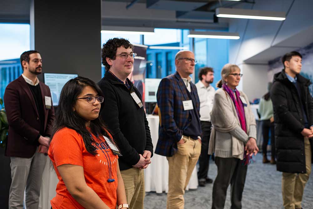 Audience of students, alumni, faculty, and staff listen to Dean Elizabeth Mynatt speak at the 40th Anniversary Celebration at the Roux Institute in Portland, ME.