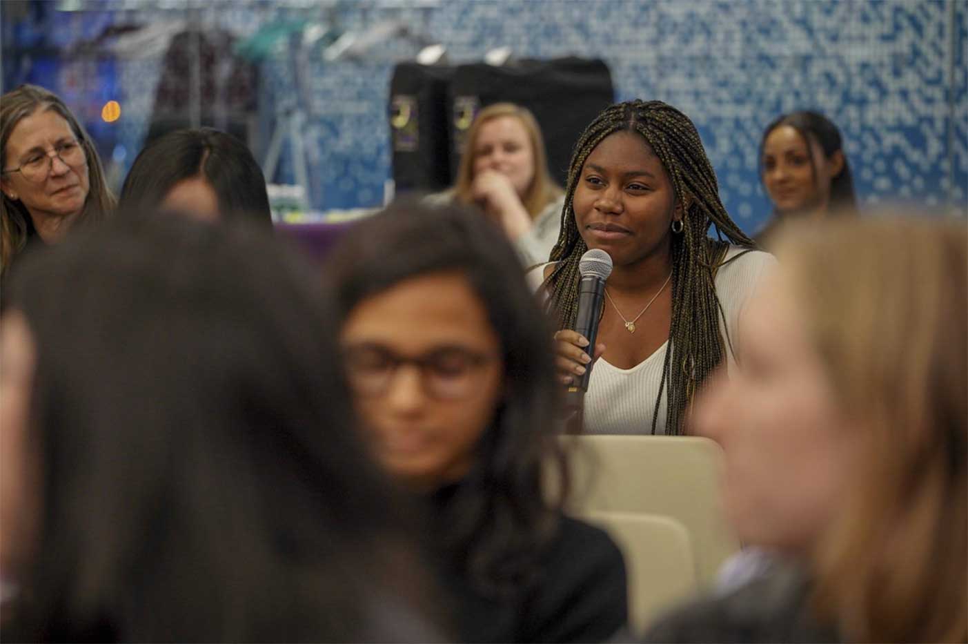 An audience member asks the panel a question