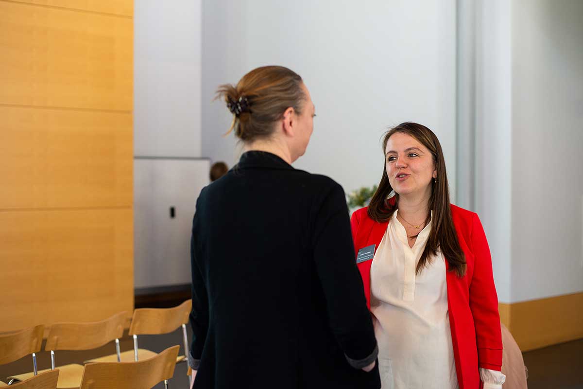 Two people talk during a break at the 40th anniversary celebration at Mills College.