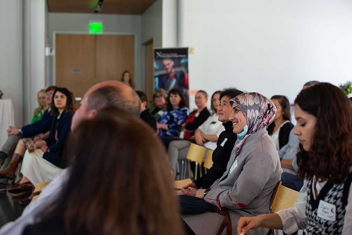 Members of the audience smile during a presentation at the 40th anniversary celebration at Mills College.