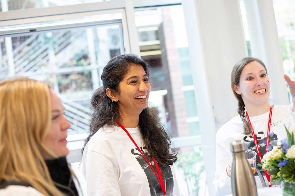 Students laugh during the networking portion of the Khoury 40th anniversary celebration in Seattle.