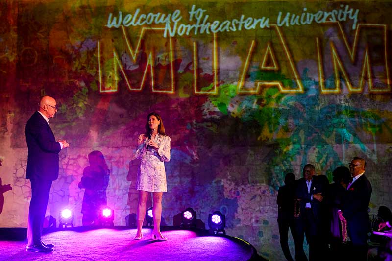 People speak on a stage at Northeastern Miami's kickoff event