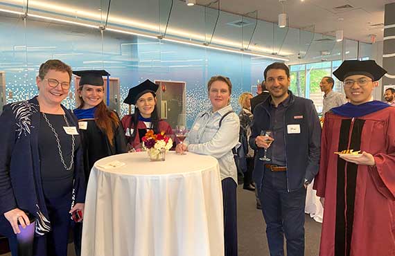 Khoury faculty, staff, and PhD students mingle at the hooding ceremony