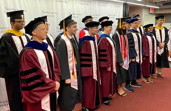 Khoury faculty, staff and students pose before marching in the ceremony