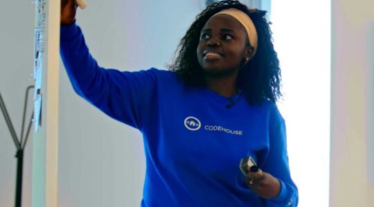 Becky Mashaido writes on a white board