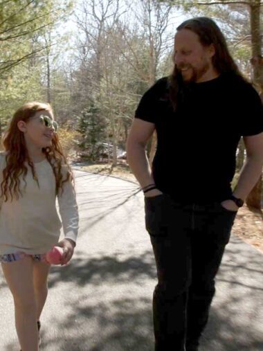 Glen Coppersmith walks with his daughter on a trail in the forest