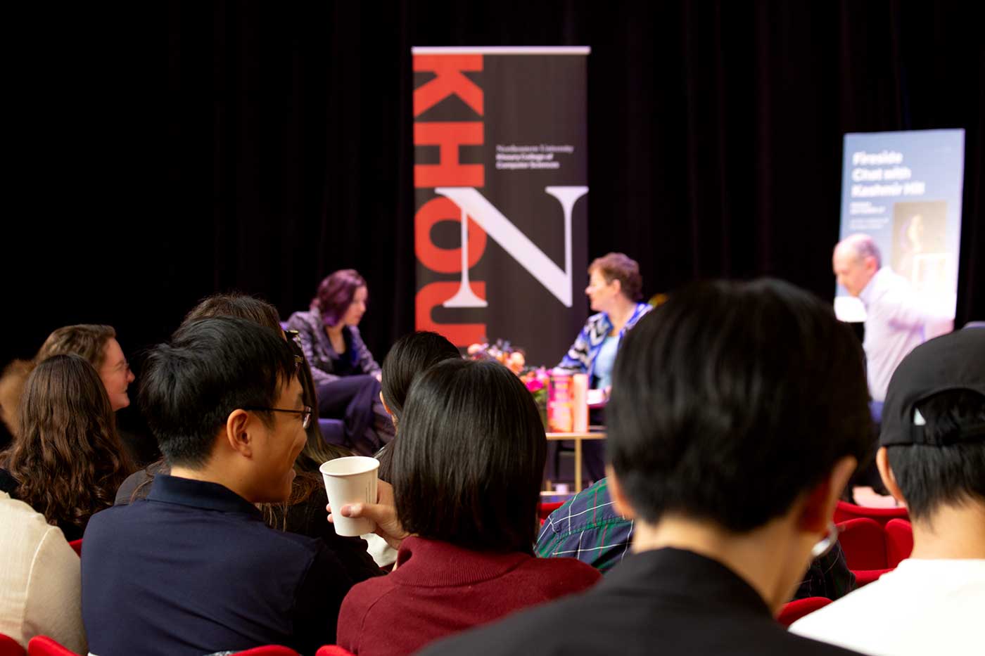 The audience watches the conversation on the event stage.