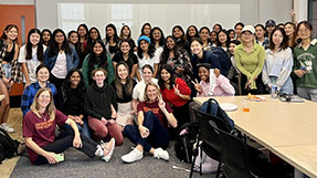 Attendees of a Northeastern Rewriting the Code event pose in a photo