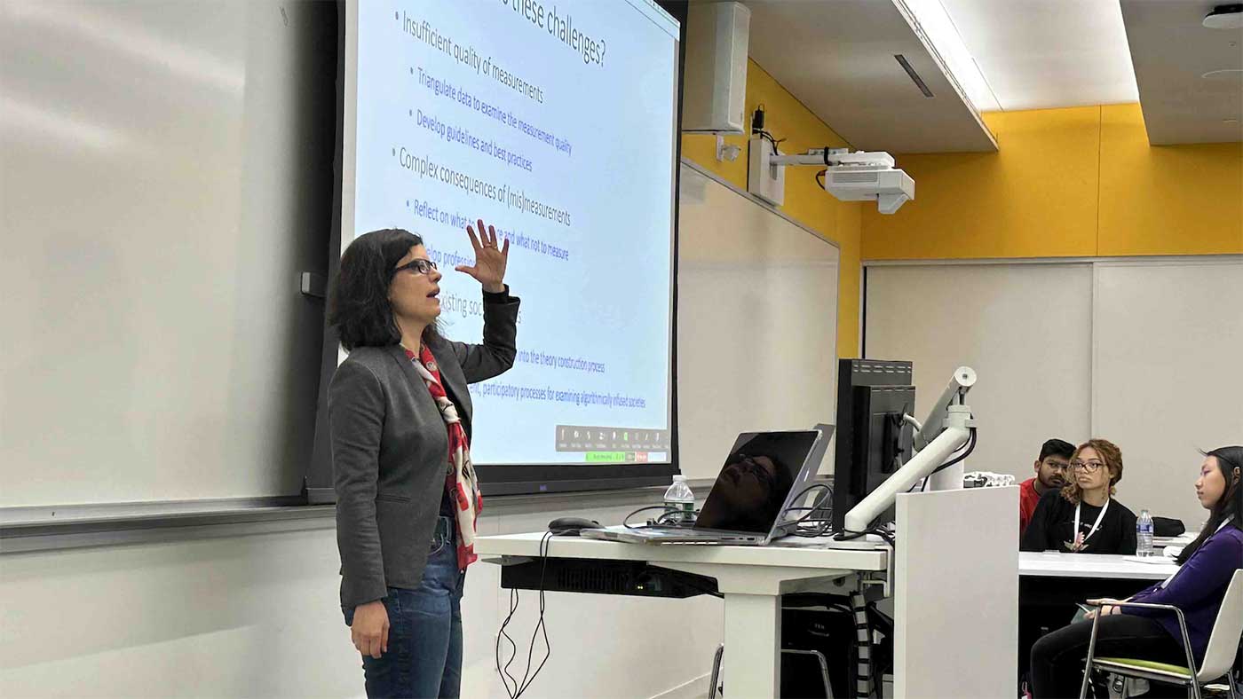 Tina Eliassi-Rad speaks to a classroom of attendees