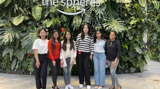 Six members of of Women in Technology - Seattle pose for a photo inside the Amazon building in Seattle.