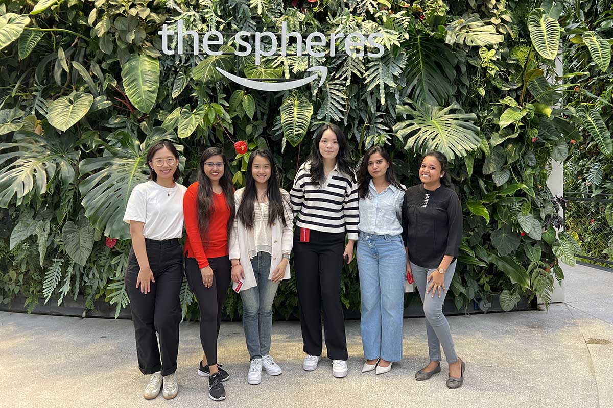 Six members of of Women in Technology - Seattle pose for a photo inside the Amazon building in Seattle.