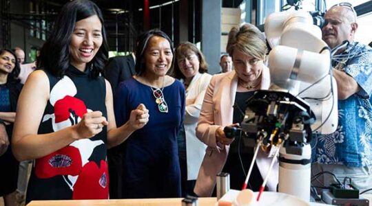 Gov. Maura Healey, Boston Mayor Michelle Wu, left, and state Economic Development Secretary Yvonne Hao, center, learn about AI and robotics.