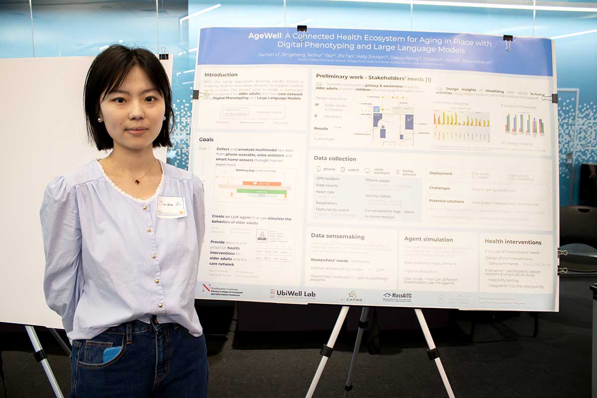 A Khoury student stands to the left of a research poster at a Khoury College research expo.