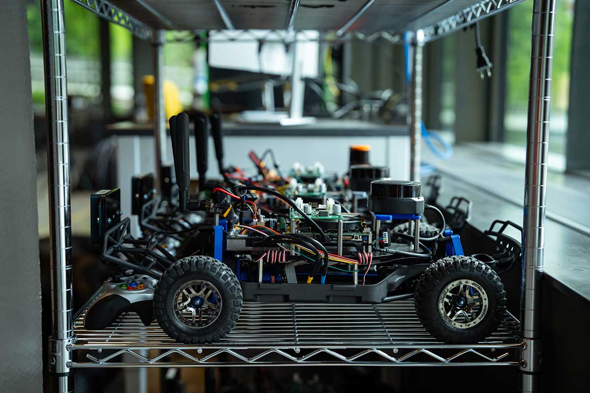 A shelf full of four-wheeled robotic vehicles