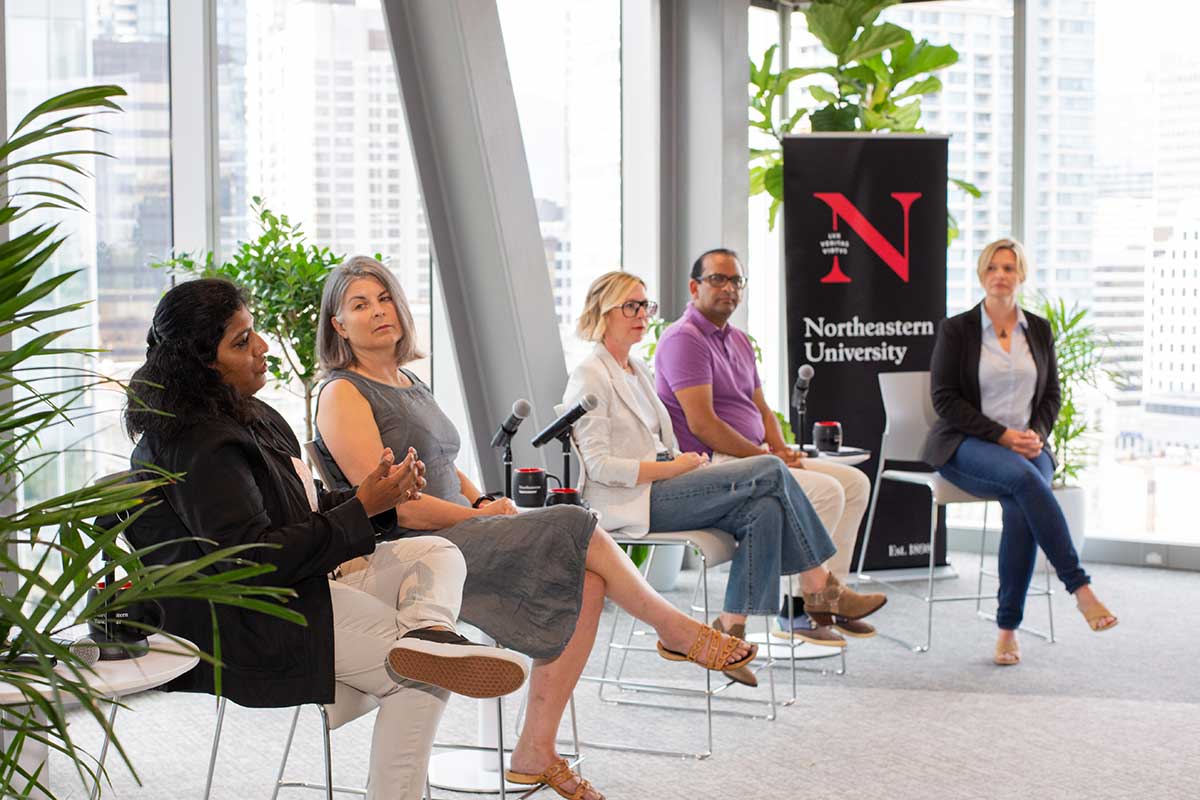 Northeastern Vancouver faculty, staff, and industry partners sit in chairs and lead a discussion during an event at Northeastern Vancouver.