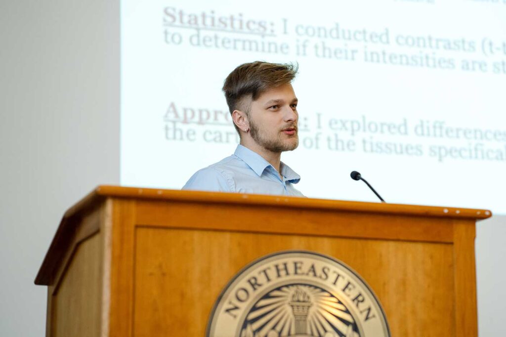 Benjamin Wolff presents a project while standing behind a podium