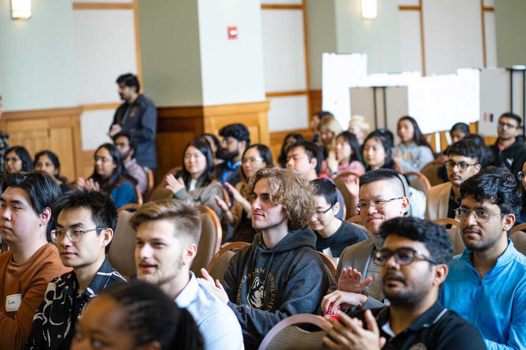 The audience at the Khoury Research Apprenticeship showcase applauds a presentation.