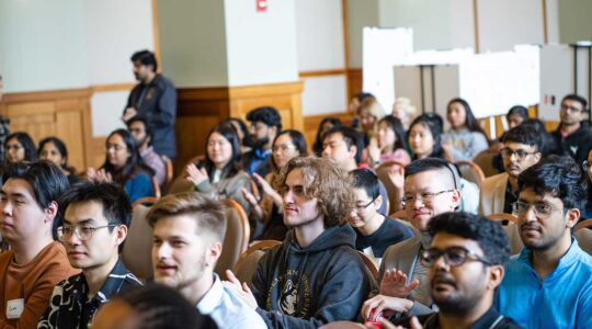 The audience at the Khoury Research Apprenticeship showcase applauds a presentation.
