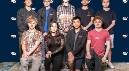 Nine members of Northeastern University’s Collegiate Cyber Defense Competition team pose for a photo at the competition.