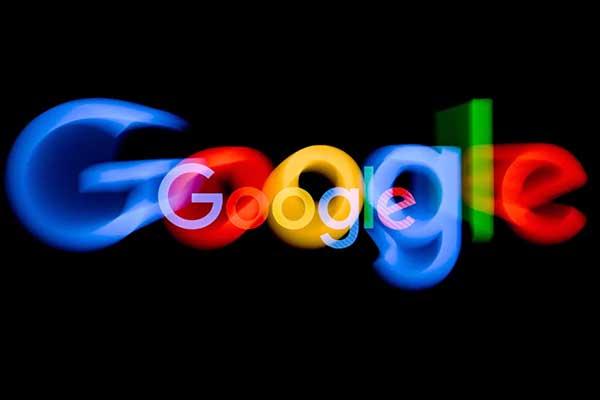 The Google logo with its letters slightly blurred on a black background