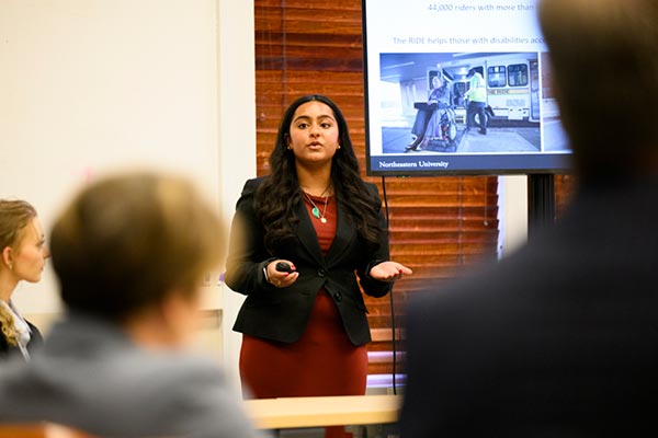 A Khoury student speakers to a an audience about her project related to transporting medical patients