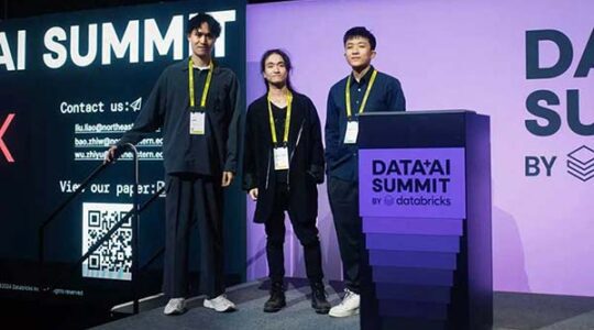 Three Northeastern Vancouver students stand on a stage at the Data AI Summit