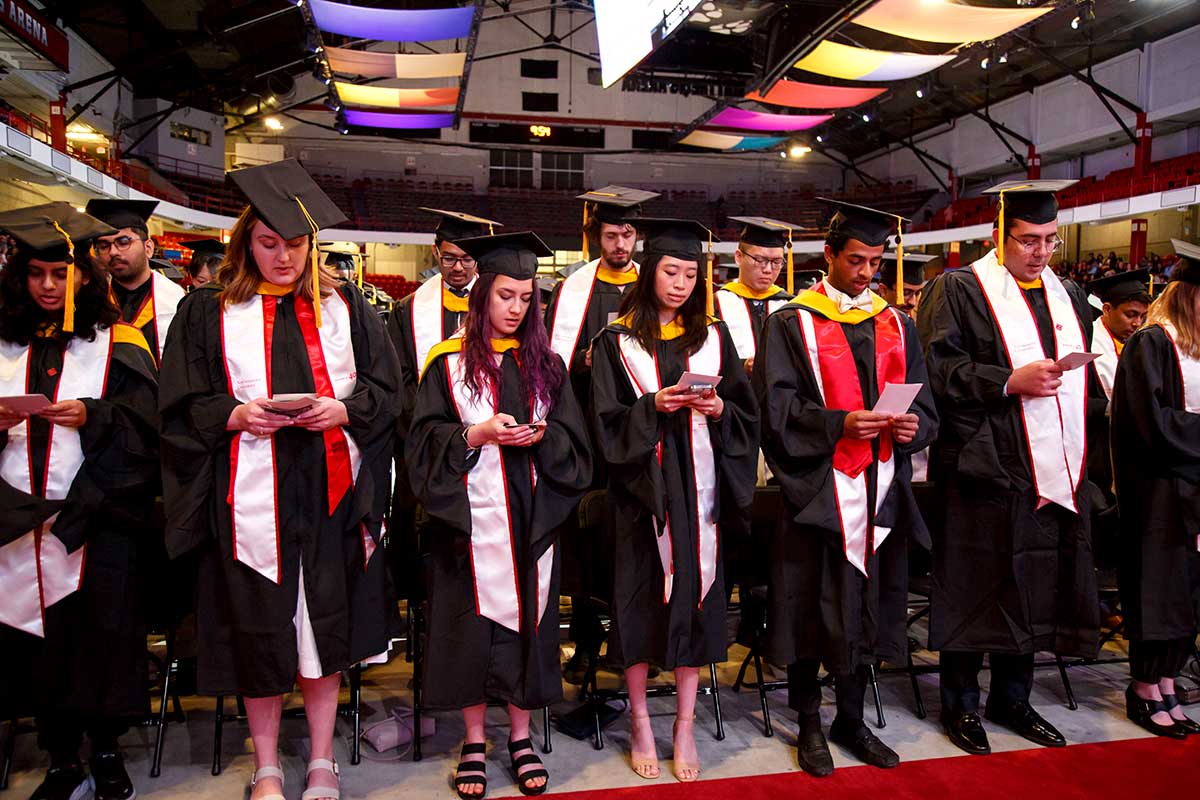 Khoury graduates read the oath while standing at the 2024 Khoury graduation celebration