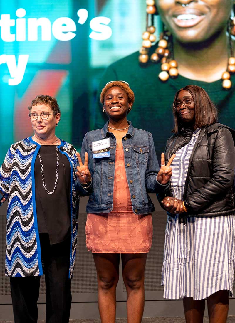 Khoury College Dean Beth Mynatt (left) stands with graduate Kristine Umeh (center) and Kristine's mother at a Khoury celebration event.