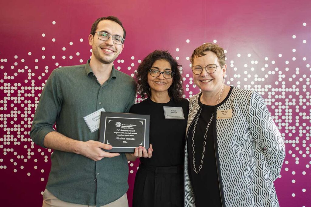 A data management student (left) holds an award plaque while standing with Khoury faculty member Amal Ahmed (center) and Dean Beth Mynatt