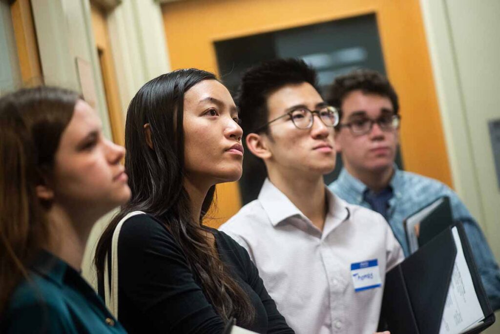 Four students look on attentively